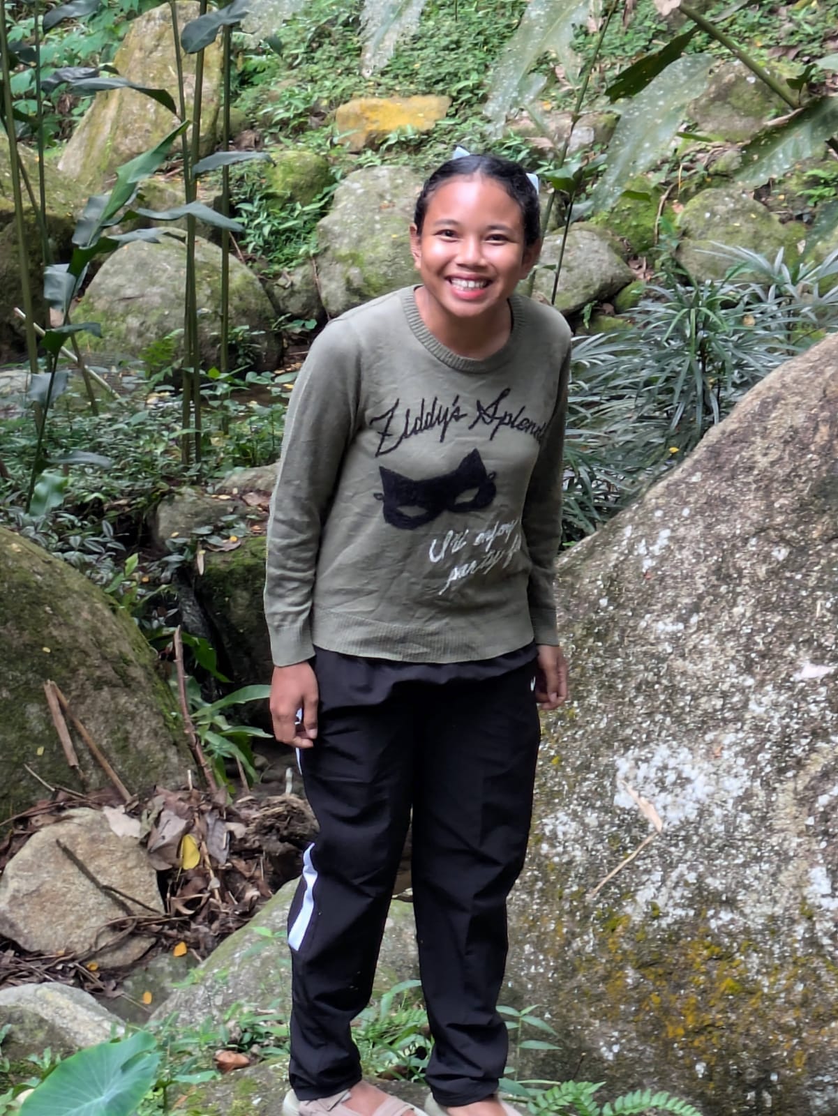 Portrait of a young woman outdoors in a forested area in Malaysia.